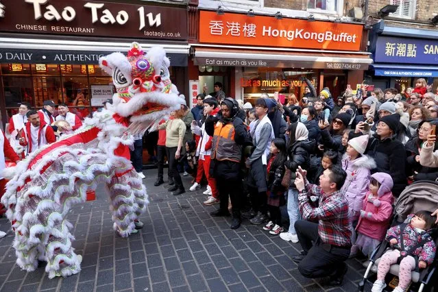 A Chinese lion dance is performed in the streets of Chinatown for the Lunar New Year in London, Britain on January 21, 2023. (Photo by Kevin Coombs/Reuters)