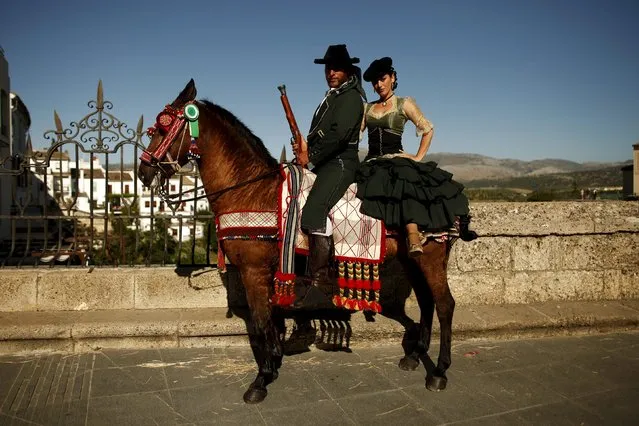 Francisco Javier Moreno (L), 35, and his wife Maria Auxiliadora Canca, 34, dressed as bandits pose for a photo with their horse as they participate in the third edition of “Ronda Romantica” (Romantic Ronda) in Ronda, southern Spain, May 16, 2015. (Photo by Jon Nazca/Reuters)