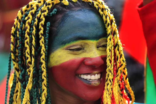 A protester from Ethiopia's community in Lebanon painted her face with the colors of her national flag, during a protest against the U.S. and other western country's intervention in her country and calling for the immediate end to Ethiopia's ongoing internal conflict, in front the United Nation Headquarters, in Beirut, Lebanon, Sunday, December 5, 2021. (Photo by Hussein Malla/AP Photo)
