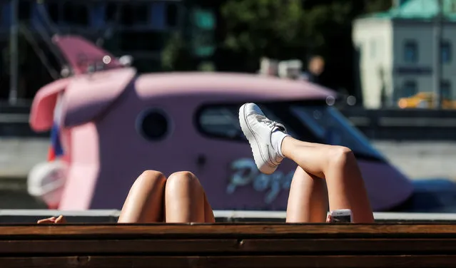 Women rest on the embankment of the Moskva River on a hot summer day in central Moscow, Russia on June 4, 2019. (Photo by Maxim Shemetov/Reuters)