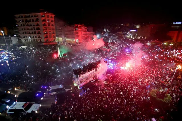 Algerian fans celebrate and welcome the Algeria team as they arrive in a bus after their FIFA Arab Cup win, in Algiers, Algeria on December 19, 2021. (Photo by Ramzi Boudina/Reuters)