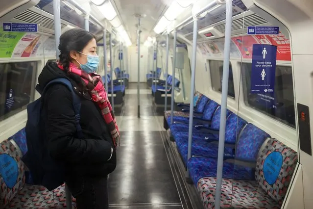 A woman stand inside an almost deserted underground train, amid the coronavirus disease (COVID-19) outbreak, in London, Britain, January 5, 2021. (Photo by Hannah McKay/Reuters)