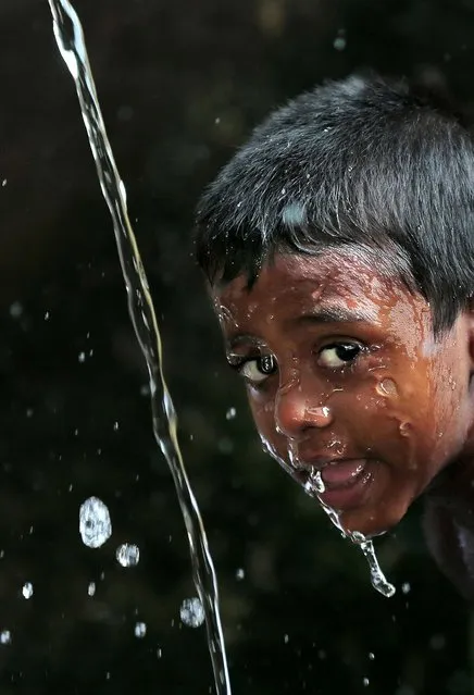 A Sri Lankan boy washes his face at a public water tap on World Water Day in Colombo, Sri Lanka, on March 22, 2014. (Photo by Eranga Jayawardena/Associated Press)