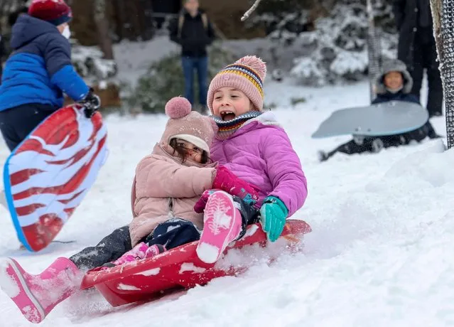 Families and children converge on Rock Creek Park for sledding following a snowstorm in Washington, U.S., January 3, 2022. (Photo by Evelyn Hockstein/Reuters)