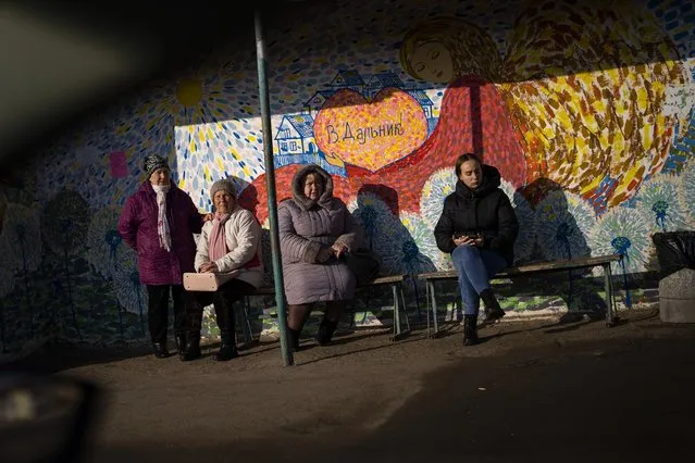 Women wait at a bus stop in Odessa, Ukraine, Thursday, February 17, 2022. (Photo by Emilio Morenatti/AP Photo)