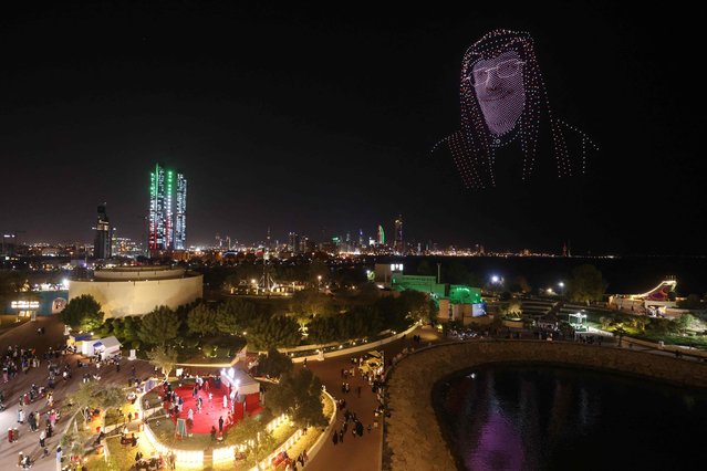 An image made out of drones in the effigy of Kuwait's Crown Prince and deputy Emir Sheikh Meshal al-Ahmad al-Jaber al-Sabah, hovers above the Green Island off the coast of Kuwait City on February 16, 2023, as the country celebrates throughout the month of February its 62nd Independence Day and the 32nd anniversary of the end of the Gulf war with the liberation of Kuwait. (Photo by Yasser Al-Zayyat/AFP Photo)