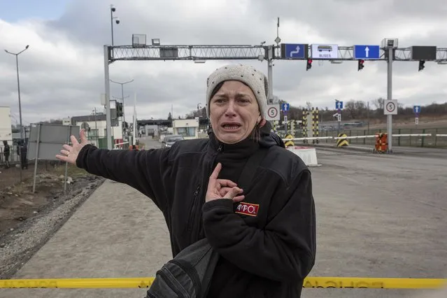 Hanna Pavlovna Lukasz, from Mirhord, Ukraine, shouts and reacts after her 12 and 8-year-old sons and her 66-year-old mother have been waiting on the Ukrainian side of the border for four days to cross at the Medyka border crossing in Poland, Monday, February 28, 2022. The head of the United Nations refugee agency says more than a half a million people had fled Ukraine since Russia’s invasion on Thursday. (Photo by Visar Kryeziu/AP Photo)