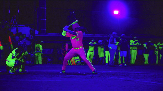 The Tri-City Chili Peppers, of Colonial Heights, Virginia, early July 2024 shed light on the “new sport” of cosmic baseball, which is becoming popular in the United States. Contests are held at night, with the field lit by black lights resulting in glowing bats, balls, bases and uniforms. The idea is the brainchild of Chris Martin, owner of the Peppers. (Photo by South West News Service)