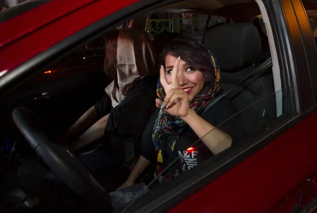 An Iranian woman gestures as she celebrates in the streets following a nuclear deal with major powers, in Tehran July 14, 2015. (Photo by Reuters/TIMA)