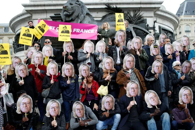 Activists wear masks depicting the face of Jean-Marie Le Pen, the founder of the French far-right National Front, with the hair of his daughter Marine Le Pen, French National Front (FN) candidate for 2017 presidential election, during a demonstration as part of traditional May Day labour day march in Paris, France on May 1, 2017. (Photo by Gonzalo Fuentes/Reuters)