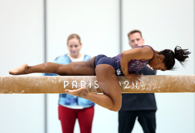 Simone Biles of the USA trains on the beam as coaches Cecile & Laurent Landi watch ahead of the Paris 2024 Olympic Games on July 24, 2024 in Paris, France. (Photo by Jamie Squire/Getty Images)