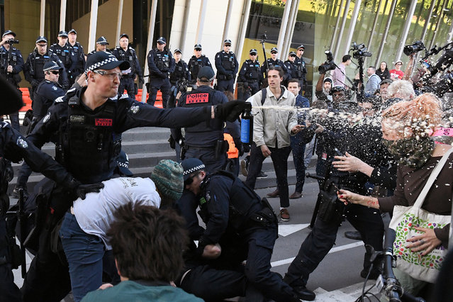 Victoria police deploy pepper spray on environmental demonstrators during a protest outside the Melbourne Exhibition and Convention Centre in Melbourne, Australia, 29 October 2019. Hundreds of climate demonstrators have converged on a conference center to protest Melbourne's International Mining and Resources Conference (IMARC). Four police officers have been injured and 40 protesters arrested. (Photo by James Ross/EPA/EFE)