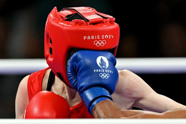 Mongolia's Yesugen Oyuntsetseg is punched by Colombia's Ingrit Lorena Valencia Victoria in the women's 50kg preliminaries round of 32 boxing match during the Paris 2024 Olympic Games at the North Paris Arena, in Villepinte on July 28, 2024. (Photo by Mohd Rasfan/AFP Photo)