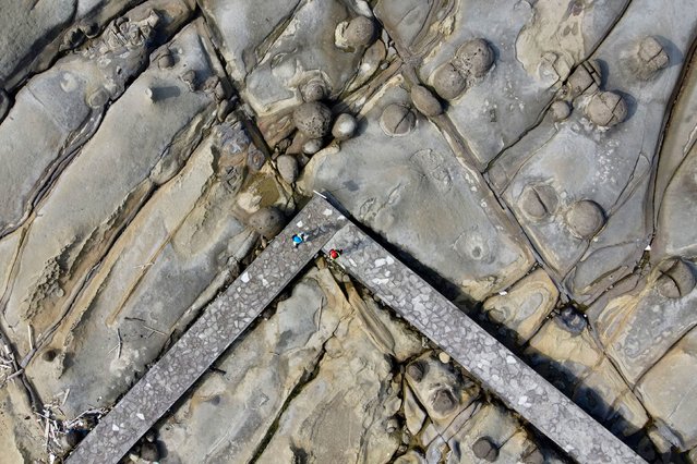 An aerial view shows people visiting Alabo Bay in the Heping Island GeoPark in Keelung, Taiwan on June 20, 2024. (Photo by Sam Yeh/AFP Photo)