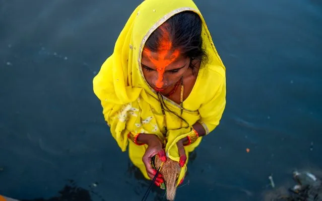 A Hindu devotee takes part in a ritual to worship the sun god during the Chhath Puja Festival in the Bagmati River in Kathmandu on November 2, 2019. The Chhath Festival, also known as Surya Pooja, or worship of the sun, is observed in parts of India and Nepal and sees devotees pay homage to the sun and water gods. (Photo by Prakash Mathema/AFP Photo)