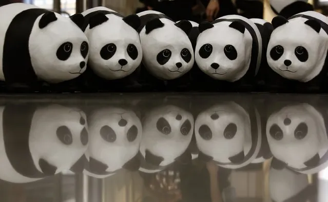 Papier-mache pandas, created by French artist Paulo Grangeon, are seen displayed at the arrival hall of the Hong Kong airport June 9, 2014. (Photo by Bobby Yip/Reuters)