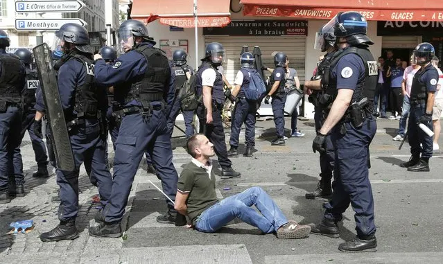 Football Soccer, Euro 2016, England vs Russia, Group B, Stade Velodrome, Marseille, France on June 11, 2016. Police detain a supporter at the old port of Marseille before the game. (Photo by Jean-Paul Pelissier/Reuters)