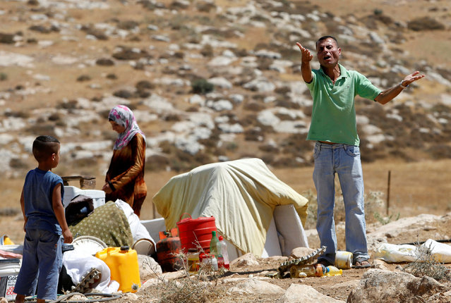 A Palestinian man reacts as Israeli troops demolish his shed near the West Bank village of Yatta, south of Hebron June 19, 2016. (Photo by Mussa Qawasma/Reuters)