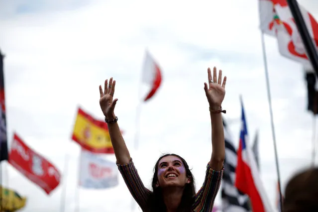 A reveller cheers before the start of the performance of the British band Madness on The Pyramid stage at Worthy Farm in Somerset during the Glastonbury Festival, Britain, June 25, 2016. (Photo by Stoyan Nenov/Reuters)