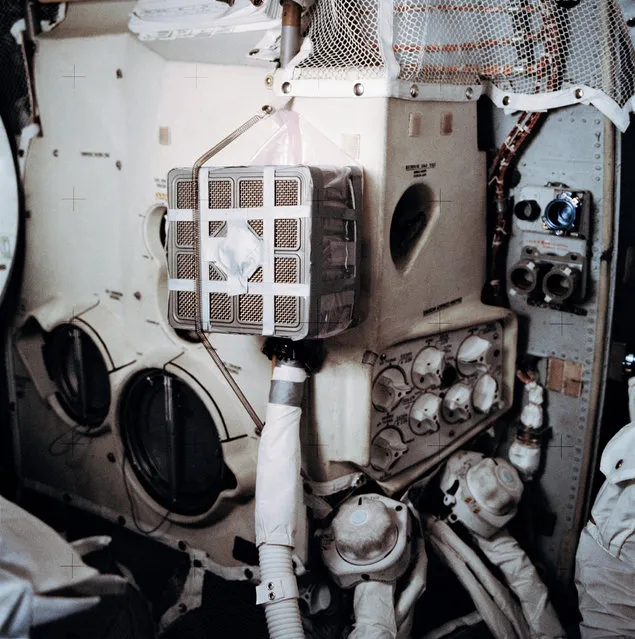 Interior view of the Apollo 13 Lunar Module (LM) showing the “mail box”, a jury-rigged arrangement which the Apollo 13 astronauts built to use the Command Module (CM) lithium hydroxide canisters to purge carbon dioxide from the LM. Lithium hydroxide is used to scrub CO2 from the spacecraft's atmosphere. Since there was a limited amount of lithium hydroxide in the LM, this arrangement was rigged up to utilize the canisters from the CM. (Photo by NASA)