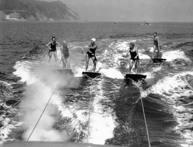 Five graceful water nymphs poised on their aquaplane boards as they flash through the water at about fifty miles an hour in one of the preliminary races in the Annual Aquaplane Championships off Catalina Island, California, July 11, 1934. (Photo by AP Photo)