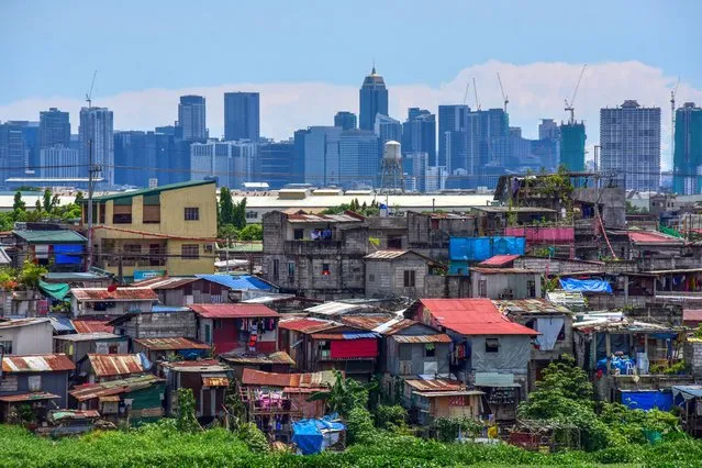 A general view shows residential and commercial buildings in Manila on May 29, 2022. (Photo by Maria Tan/AFP Photo)