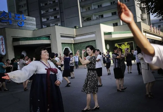 North Koreans dance in downtown Pyongyang during celebrations of the armistice that ended the Korean War, on Jule 27, 2014. (Photo by Wong Maye-E/AP Photo)