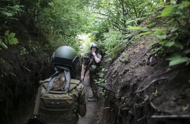 Ukrainian servicemen walk to their positions near the Zaytseve village of the Donetsk region, Ukraine, 29 May 2022. On 24 February, Russian troops invaded Ukrainian territory starting a conflict that has provoked destruction and a humanitarian crisis. According to the UNHCR, more than 6.5 million refugees are estimated to have fled Ukraine, and a further seven million people estimated to have been displaced internally within Ukraine since. (Photo by EPA/EFE/Stringer)