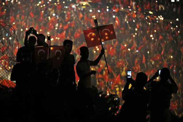 Pro-government supporters, waving Turkish flags protest on the road leading to Istanbul's iconic Bosporus Bridge, Thursday, July 21, 2016. Turkish lawmakers approved a three-month state of emergency, endorsing new powers for Turkey's President Recep Tayyip Erdogan that would allow him to expand a crackdown that has already included mass arrests and the closure of hundreds of schools, in the wake of the July 15 failed coup. (Photo by Emrah Gurel/AP Photo)