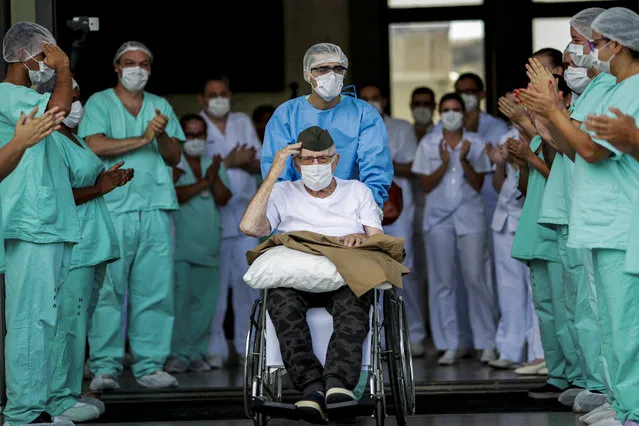 Brazilian 99-year-old former WWII combatant Ermando Armelino Piveta gestures as he leaves the Armed Forces Hospital, after being treated for the coronavirus disease (COVID-19) and discharged, in Brasilia, Brazil, April 14, 2020. (Photo by Ueslei Marcelino/Reuters)