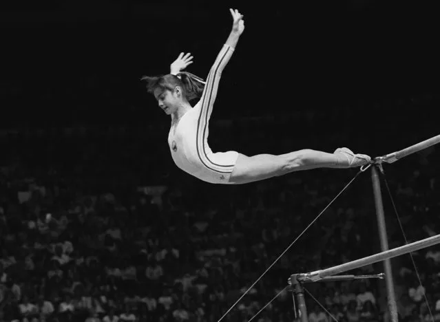 Nadia Comaneci, of Romania, dismounts from the uneven parallel bars during a perfect «10» performance at the Summer Olympic Games in Montreal, Canada, July 18, 1976. (Photo by Paul Vathis/AP Photo)