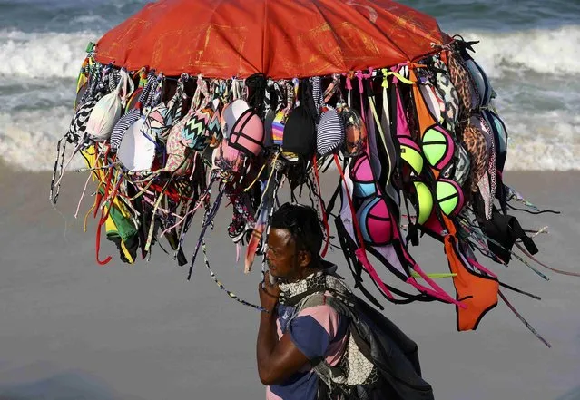 A vendor peddles bikinis along Copacabana Beach a day before the opening ceremony of the Rio 2016 Olympic Games in Rio de Janeiro, Brazil, August 4, 2016. (Photo by Paul Hanna/Reuters)