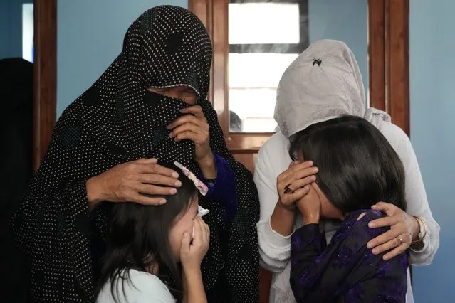 The family of a 19-years old girl who was victim of a suicide bomber mourns, in Kabul, Afghanistan, Friday, September 30, 2022. (Photo by Ebrahim Noroozi/AP Photo)