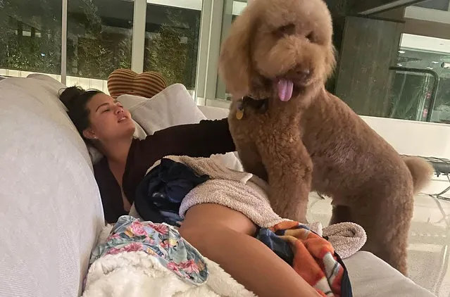 American model and television personality Chrissy Teigen early October 2022 enjoys a “lazy weekend” with one of her dogs. (Photo by chrissyteigen/Instagram)