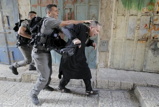 Israeli border police officers detain a Palestinian protester in Jerusalem's Old City,September 14, 2015. Israeli police raided the plaza outside Jerusalem's al-Aqsa mosque on Sunday in what they said was a bid to head off Palestinian attempts to disrupt visits by Jews and foreign tourists on the eve of the Jewish New Year. (Photo by Ammar Awad/Reuters)