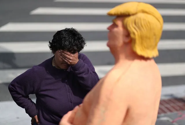 A passerby looks at a statue depicting republican presidential nominee Donald Trump in the nude on August 18, 2016 in San Francisco, United States. Anarchist collective INDECLINE has created five statues depicting Donald Trump in the nude and placed them in five U.S. cities on Thursday morning. The statues are in San Francisco, New York, Los Angeles, Cleveland and Seattle. (Photo by Justin Sullivan/Getty Images)