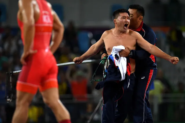 Mongolias coaches protest the judges decision after Mandakhnaran Ganzorig (red) of Mongolia is defeated by Ikhtiyor Navruzov (blue) of Uzbekistan in the Men's Freestyle 65kg Bronze match against  on Day 16 of the Rio 2016 Olympic Games at Carioca Arena 2 on August 21, 2016 in Rio de Janeiro, Brazil. (Photo by Laurence Griffiths/Getty Images)