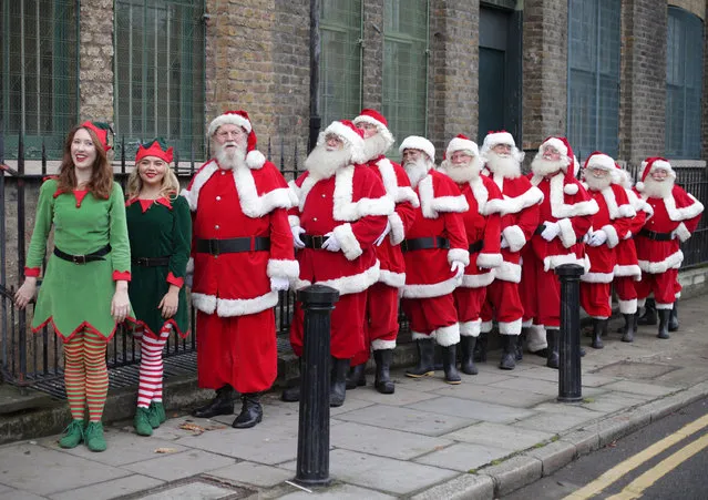 Father Christmas and Elf performers take part in a posed classroom photocall for the media for the Ministry of Fun Santa School at the Ragged School Museum in east London, Thursday, November 16, 2017. (Photo by  Yui Mok/PA Wire)