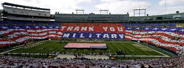 Fans honor those who serve the country before the Packers - Cardinals game in Green Bay. (Photo by Jeffrey Phelps/Associated Press)