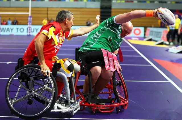Phil Roberts of Ireland scores their team's first try while under pressure from Raphael Monedero of Spain during the Wheelchair Rugby League World Cup Group A match between Spain and Ireland at Copper Box Arena on November 03, 2022 in London, England. (Photo by Bryn Lennon/Getty Images)