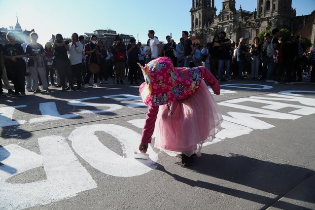 A girl takes part in a vigil for the victims of the clandestine mass grave recently found in Teuchitlan, in the state of Jalisco, at Zocalo square, in Mexico City, Mexico on March 15, 2025. (Photo by Seila Montes/Reuters)