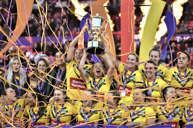 Australia's players celebrate with the trophy after winning during the Women's Rugby League World Cup final match between Australia and New Zealand at the Old Trafford stadium in Manchester, England, Saturday, November 19, 2022. (Photo by Rui Vieira/AP Photo)