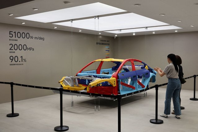 People look at the interior structure of the Xiaomi SU7 electric vehicle during a media day for the Auto Shanghai show in Shanghai, China on April 23, 2025. (Photo by Go Nakamura/Reuters)