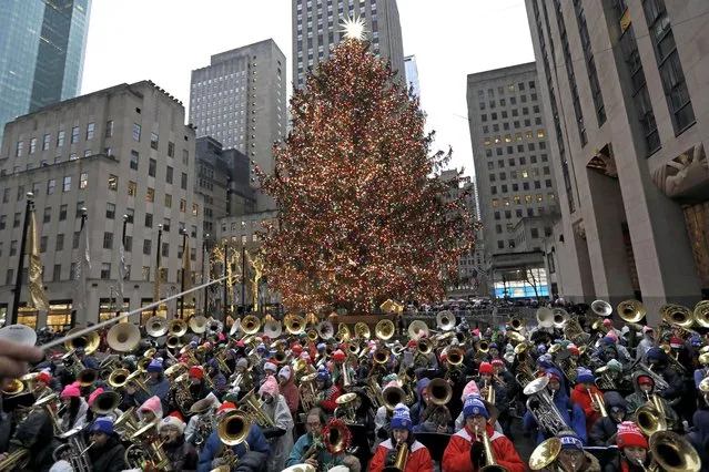 Tenor and bass tuba players perform traditional Christmas carols at the 49th Annual Tuba Christmas at Rockefeller Center in New York, New York, USA, 11 December 2022. (Photo by Peter Foley/EPA/EFE)