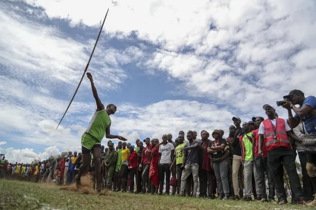 A Maasai man throws a javelin as he competes in the Maasai Olympics in Kimana Sanctuary, southern Kenya Saturday, December 10, 2022. (Photo by Brian Inganga/AP Photo)