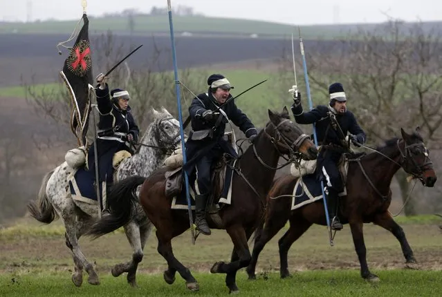 Historical re-enactment enthusiasts dressed as soldiers ride horses near the southern Moravian village of Herspice November 28, 2014. (Photo by David W. Cerny/Reuters)