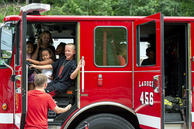 Children play in a Charleston Fire Department fire truck at National Night Out in Charleston, West Virginia on Tuesday, August 5, 2025. (Photo by Laura Bilson/Charleston Gazette-Mail via AP Photo)