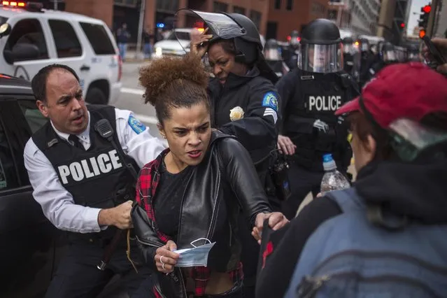 A protester (C) demanding justice for Michael Brown tries to hold on to a fellow protester (R) as she is detained by police in riot gear for disrupting traffic in downtown St. Louis, Missouri November 30, 2014. Officer Darren Wilson announced his resignation late Saturday, saying he feared for his own safety and that of his fellow police officers after a grand jury decided not to indict him in the fatal Aug. 9 shooting of 18-year-old Michael Brown. (Photo by Adrees Latif/Reuters)