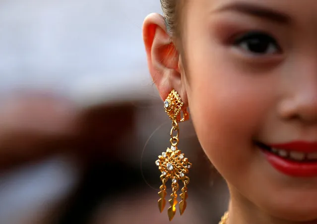 A girl wearing an earring is seen as she celebrates Makha Bucha Day near a temple in Bangkok, Thailand, March 1, 2018. (Photo by Soe Zeya Tun/Reuters)
