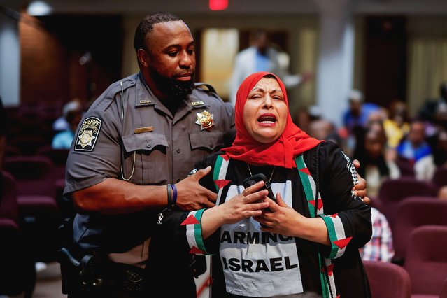 A Fulton County Sheriff deputy (L) intervenes as Palestinian activist Jawahir Kamil (R) confronts Democratic US Representative of Georgia Nikema Williams about the Hamas-Israel conflict during a Congressional town hall with constituents in Atlanta, Georgia, USA, 14 August 2025. Williams, who represents Georgia's 5th Congressional district, was cohosting the town hall with Atlanta City Council member Andrea L. Boone. (Photo by Erik S. Lesser/EPA)